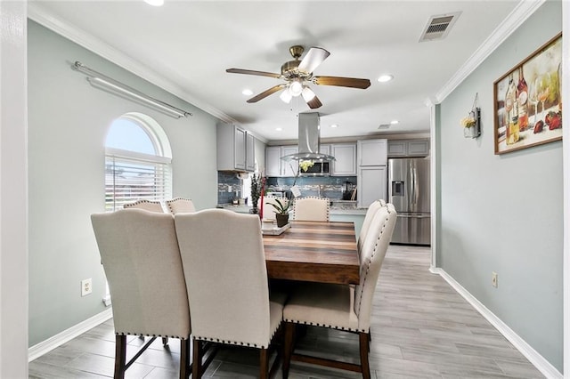 9 Osborne Ave, Kenner, LA 70065 - dining room featuring ornamental molding, a ceiling fan, recessed lighting, baseboards, and light wood-type flooring