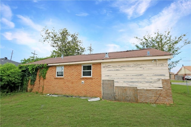 8018 Mackenzie St, New Orleans, LA 70128 - back of house with a lawn and brick siding