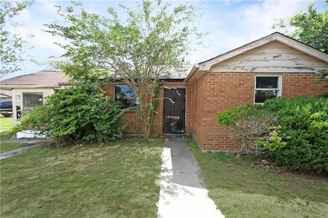 8018 Mackenzie St, New Orleans, LA 70128 - view of front of property with brick siding and a front yard