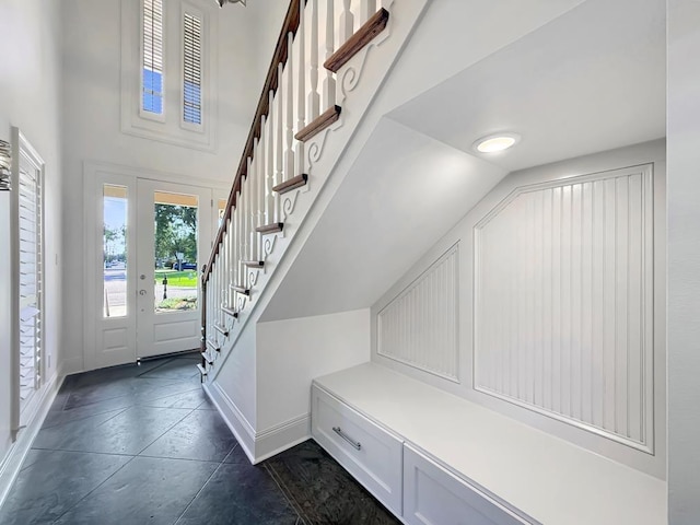 9125 5th St, River Ridge, LA 70123 - entrance foyer with baseboards, stairway, and high vaulted ceiling