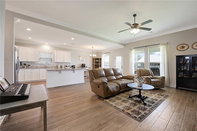 229 Louisiana Iris Cir, Slidell, LA 70458 - living room with a chandelier, light wood finished floors, ceiling fan, recessed lighting, and ornamental molding