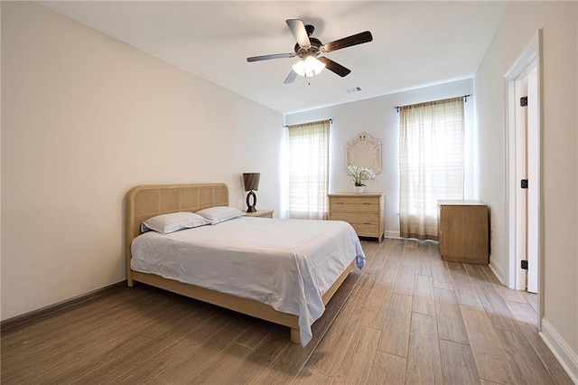229 Louisiana Iris Cir, Slidell, LA 70458 - bedroom featuring light wood finished floors, baseboards, and a ceiling fan