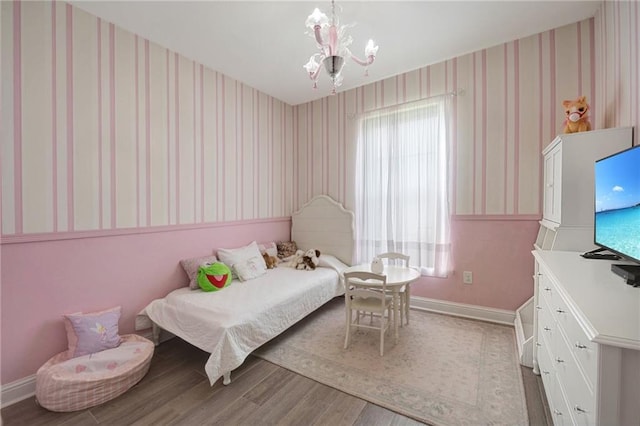 229 Louisiana Iris Cir, Slidell, LA 70458 - bedroom featuring wallpapered walls, baseboards, wood finished floors, and a chandelier
