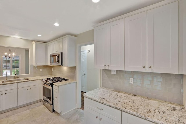 314 E Pineridge St Unit 314, Mandeville, LA 70448 - kitchen with appliances with stainless steel finishes, a sink, white cabinetry, backsplash, and recessed lighting