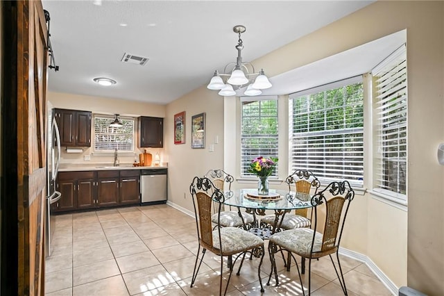 1532 Broadmoor Dr, Slidell, LA 70458 - dining area with light tile patterned floors, baseboards, and a chandelier