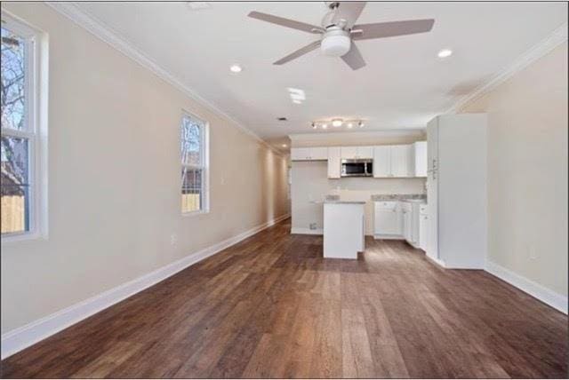 921 Andry St, New Orleans, LA 70117 - unfurnished living room featuring ornamental molding, dark wood-type flooring, baseboards, a ceiling fan, and recessed lighting