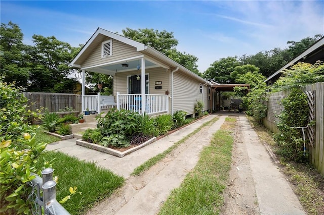 921 Andry St, New Orleans, LA 70117 - shotgun-style home with driveway and a porch