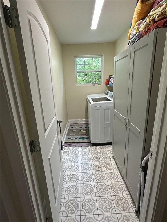 921 Andry St, New Orleans, LA 70117 - laundry area with washer and clothes dryer, light tile patterned floors, and baseboards