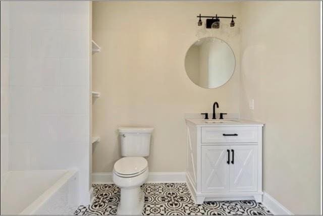 921 Andry St, New Orleans, LA 70117 - bathroom featuring toilet, tile patterned flooring, baseboards, and vanity