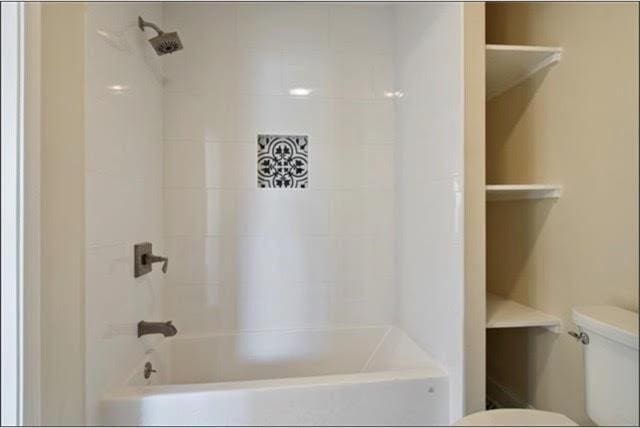 921 Andry St, New Orleans, LA 70117 - bathroom with toilet and bathtub / shower combination