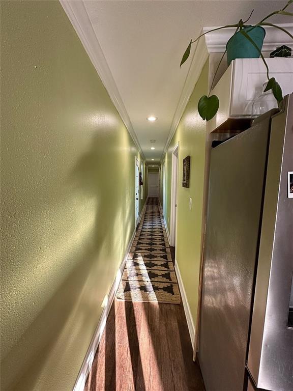 921 Andry St, New Orleans, LA 70117 - hallway with crown molding, baseboards, wood finished floors, and recessed lighting