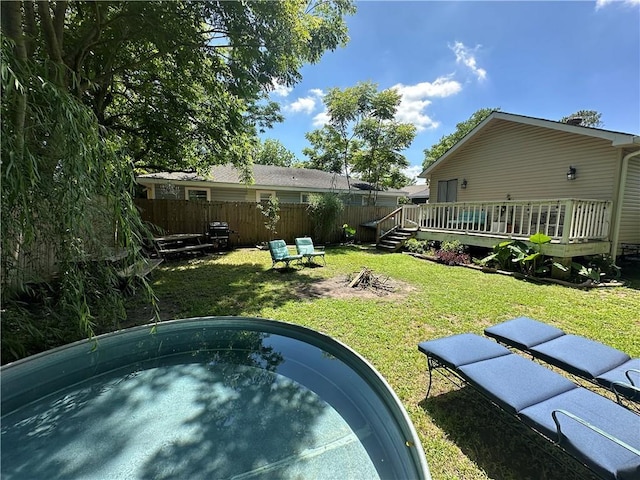 921 Andry St, New Orleans, LA 70117 - view of yard featuring an outdoor fire pit and a wooden deck