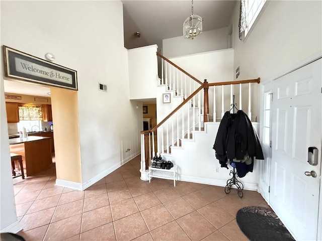 112 Cedarwood Dr, Slidell, LA 70461 - foyer entrance featuring a towering ceiling, stairs, light tile patterned floors, baseboards, and a chandelier