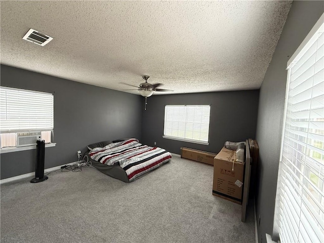 112 Cedarwood Dr, Slidell, LA 70461 - bedroom featuring cooling unit, carpet flooring, a textured ceiling, ceiling fan, and baseboards