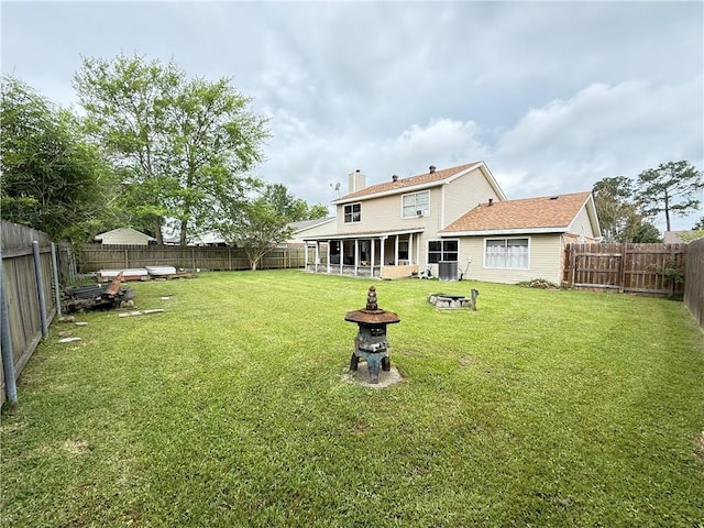 112 Cedarwood Dr, Slidell, LA 70461 - rear view of property with a fire pit, a chimney, and central AC