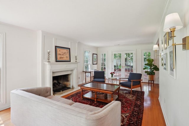 42 Riverdale Dr, Covington, LA 70433 - living area with light wood finished floors, a fireplace, and ornamental molding