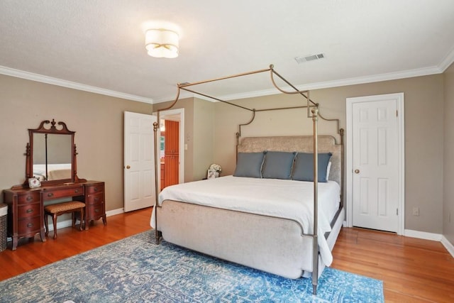 42 Riverdale Dr, Covington, LA 70433 - bedroom with wood finished floors, ornamental molding, and baseboards
