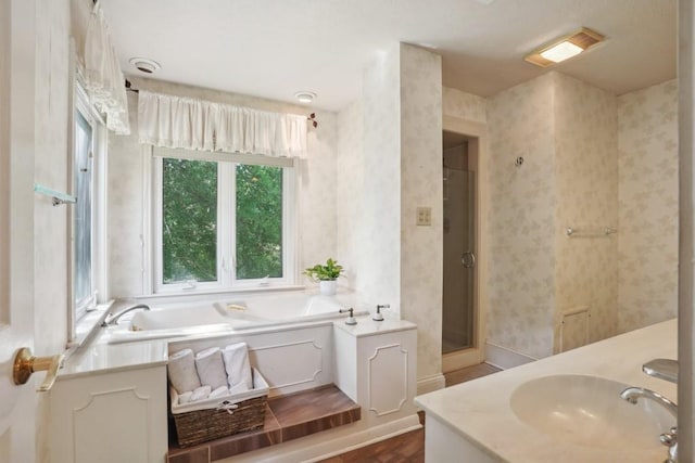 42 Riverdale Dr, Covington, LA 70433 - bathroom featuring wallpapered walls, a garden tub, a shower stall, and vanity