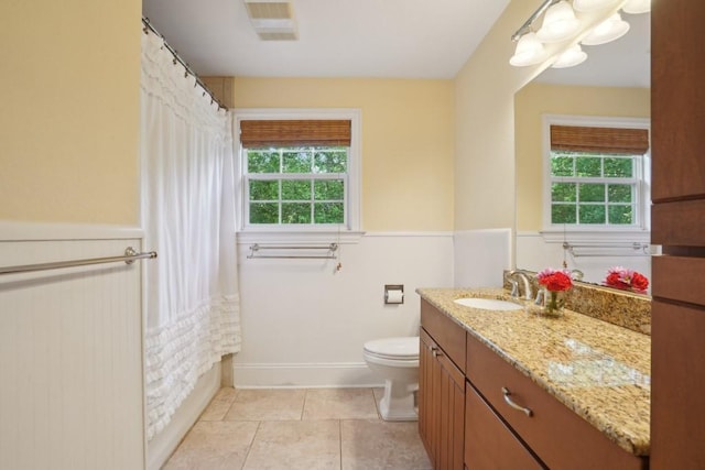 42 Riverdale Dr, Covington, LA 70433 - bathroom with healthy amount of natural light, vanity, toilet, wainscoting, and a shower with curtain
