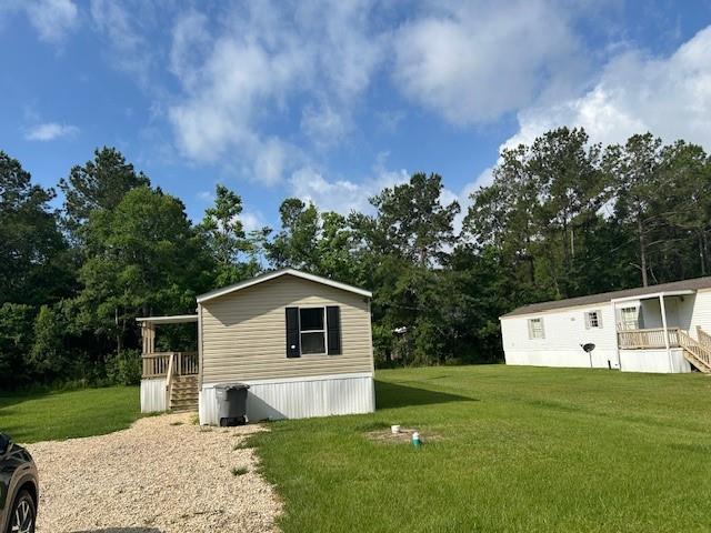 26214 E Sycamore St, Lacombe, LA 70445 - view of outbuilding featuring view of scattered trees