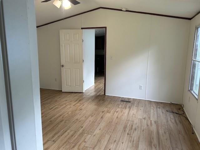 26214 E Sycamore St, Lacombe, LA 70445 - unfurnished room with a ceiling fan, light wood-style flooring, vaulted ceiling, and crown molding