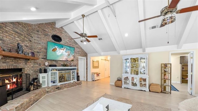 61258 N Military Rd, Slidell, LA 70461 - living area with ceiling fan, a fireplace, wood finished floors, high vaulted ceiling, and beam ceiling