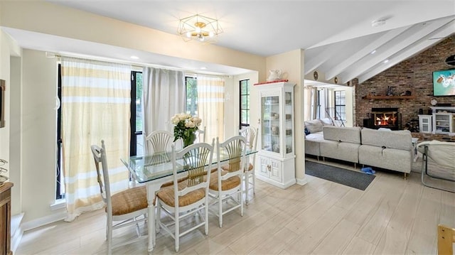 61258 N Military Rd, Slidell, LA 70461 - dining space with light wood-style flooring, a brick fireplace, and baseboards
