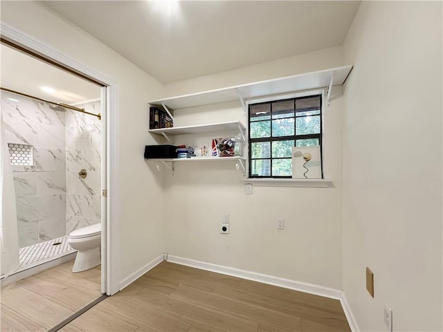 61258 N Military Rd, Slidell, LA 70461 - washroom featuring electric dryer hookup, baseboards, and wood finished floors
