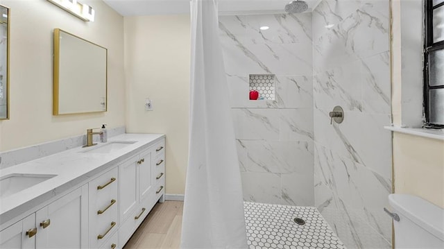 61258 N Military Rd, Slidell, LA 70461 - bathroom featuring double vanity, tiled shower, and toilet