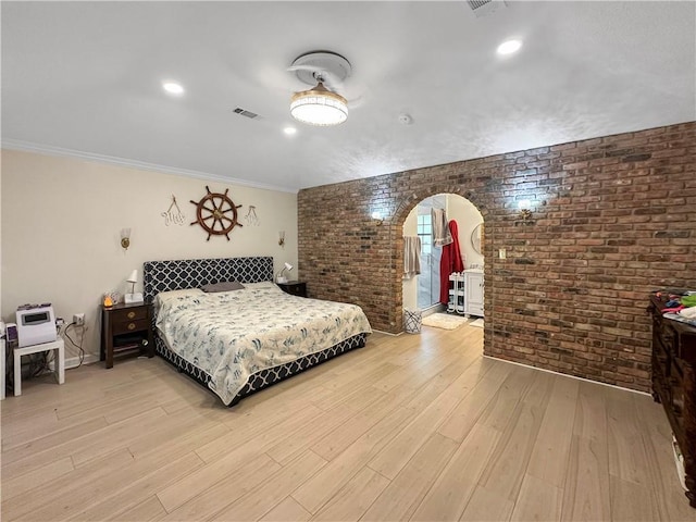 61258 N Military Rd, Slidell, LA 70461 - bedroom featuring brick wall, arched walkways, and light wood-type flooring