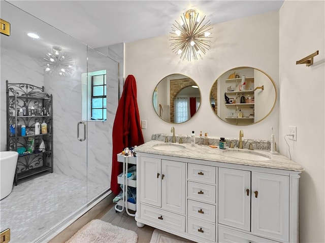 61258 N Military Rd, Slidell, LA 70461 - bathroom with a chandelier, a marble finish shower, wood finished floors, and double vanity