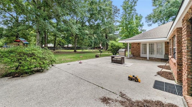 61258 N Military Rd, Slidell, LA 70461 - view of patio / terrace featuring french doors and view of scattered trees