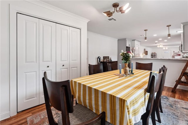 1101 Fairway Dr, Kenner, LA 70062 - dining area with crown molding, wood finished floors, baseboards, and a chandelier