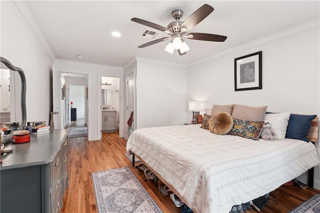 1101 Fairway Dr, Kenner, LA 70062 - bedroom featuring light wood finished floors, crown molding, ceiling fan, and ensuite bath