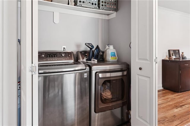 1101 Fairway Dr, Kenner, LA 70062 - laundry room featuring washer and clothes dryer and wood finished floors