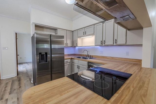 1113 Rose Meadow Loop, Slidell, LA 70460 - kitchen with appliances with stainless steel finishes, a sink, butcher block countertops, ornamental molding, and wood finished floors