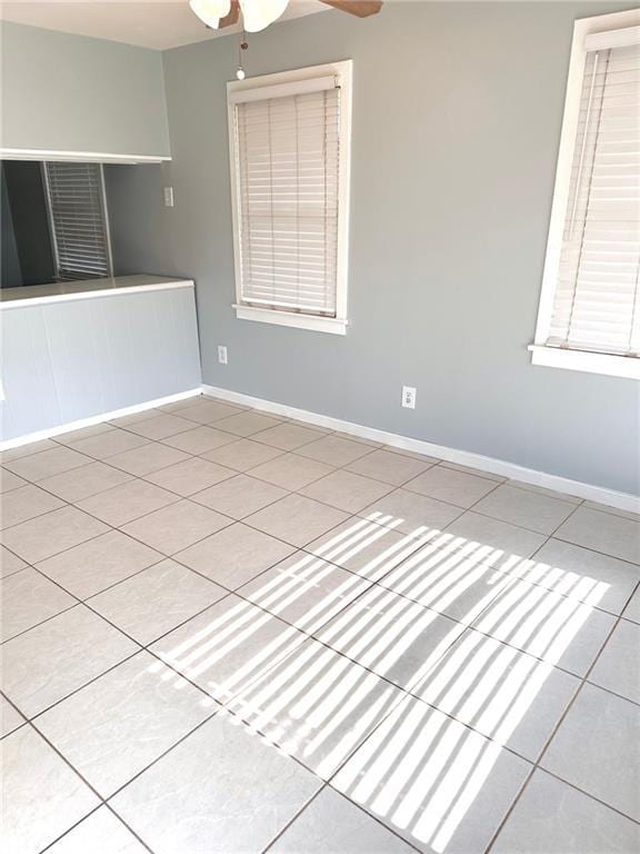 2228 Kentucky Ave, Kenner, LA 70062 - empty room with tile patterned flooring, a ceiling fan, and baseboards