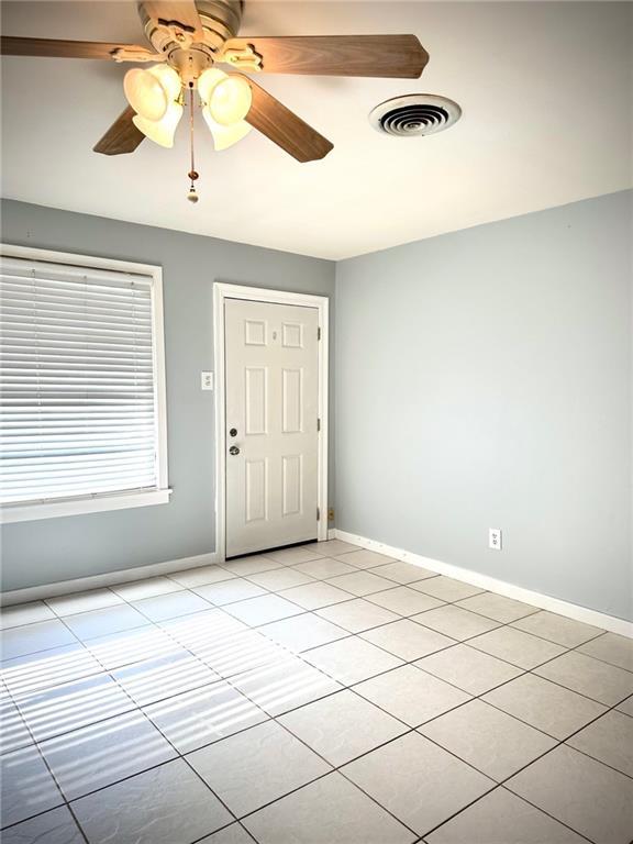 2228 Kentucky Ave, Kenner, LA 70062 - entryway with light tile patterned flooring, baseboards, and a ceiling fan