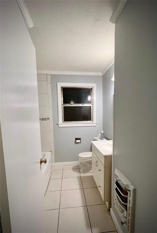 2228 Kentucky Ave, Kenner, LA 70062 - full bath with heating unit, tile patterned floors, a textured ceiling, vanity, and toilet