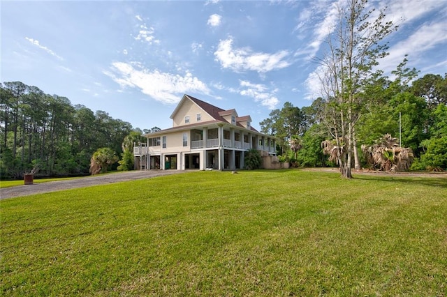 59394 E Harbor Ln, Lacombe, LA 70445 - view of front of house featuring an attached garage, driveway, and a front lawn