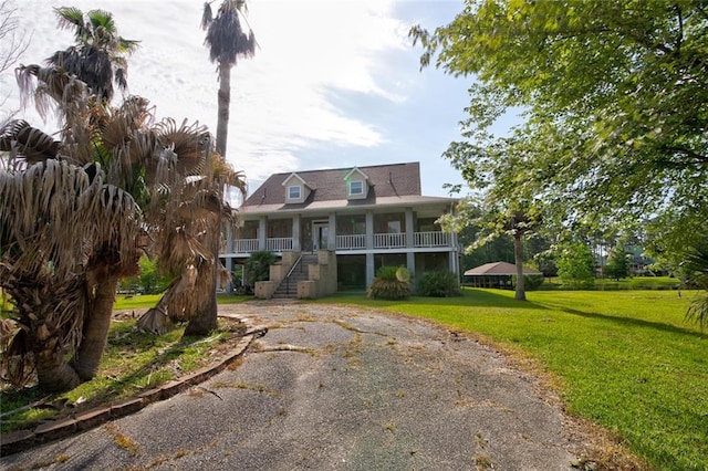 59394 E Harbor Ln, Lacombe, LA 70445 - view of front facade with stairs, a porch, a front yard, and driveway