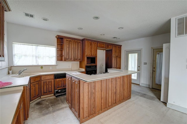 59394 E Harbor Ln, Lacombe, LA 70445 - kitchen featuring a sink, black oven, brown cabinetry, a kitchen island, and a textured ceiling