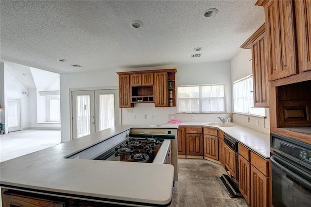 59394 E Harbor Ln, Lacombe, LA 70445 - kitchen featuring black oven, open shelves, a kitchen island, a textured ceiling, and brown cabinetry
