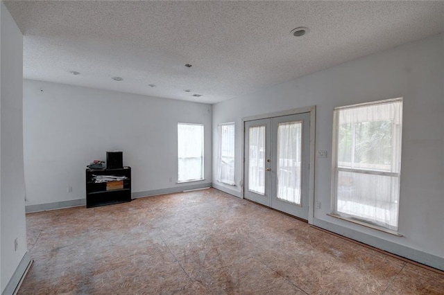 59394 E Harbor Ln, Lacombe, LA 70445 - unfurnished living room with french doors, carpet floors, a textured ceiling, and baseboards