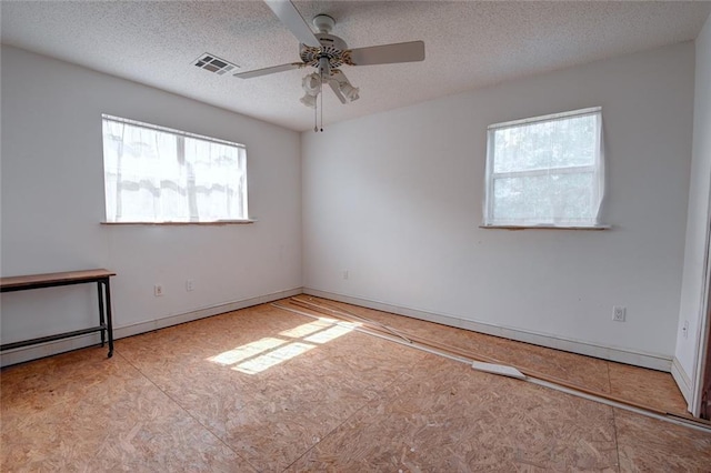 59394 E Harbor Ln, Lacombe, LA 70445 - unfurnished room featuring healthy amount of natural light, ceiling fan, a textured ceiling, and baseboards