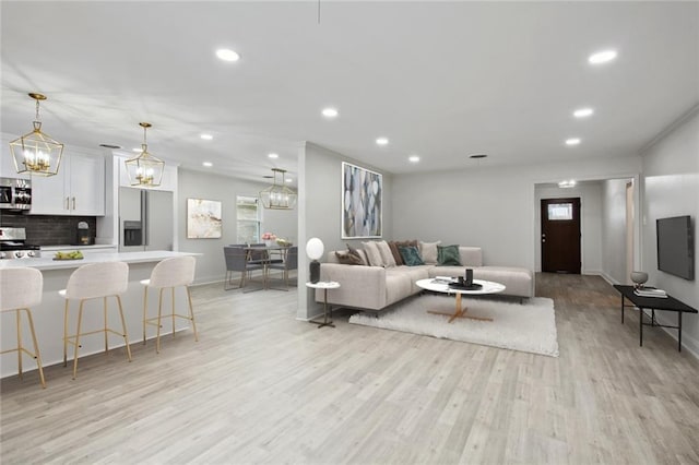 3313 Clifford Dr, Metairie, LA 70002 - living room with light wood-style floors, baseboards, recessed lighting, and a chandelier