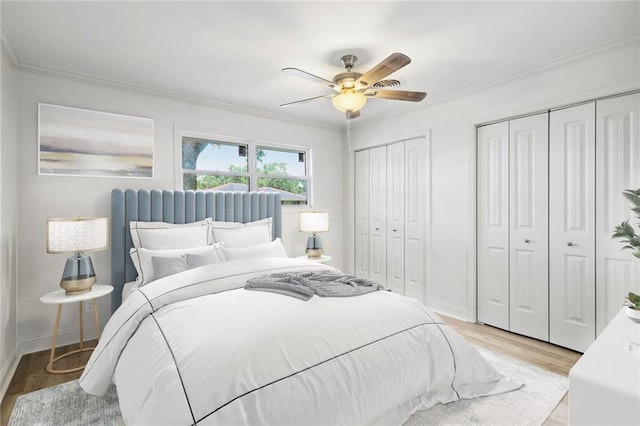 3313 Clifford Dr, Metairie, LA 70002 - bedroom with light wood-style floors, two closets, ornamental molding, a ceiling fan, and baseboards