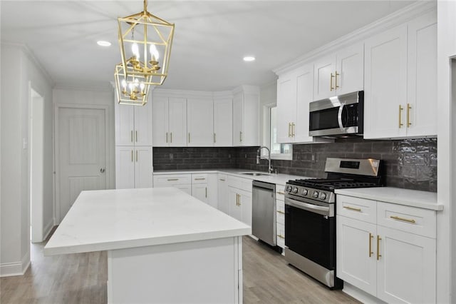 3313 Clifford Dr, Metairie, LA 70002 - kitchen with stainless steel appliances, a sink, a center island, tasteful backsplash, and white cabinetry