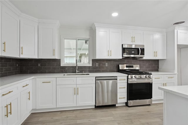 3313 Clifford Dr, Metairie, LA 70002 - kitchen with appliances with stainless steel finishes, a sink, white cabinetry, light countertops, and decorative backsplash