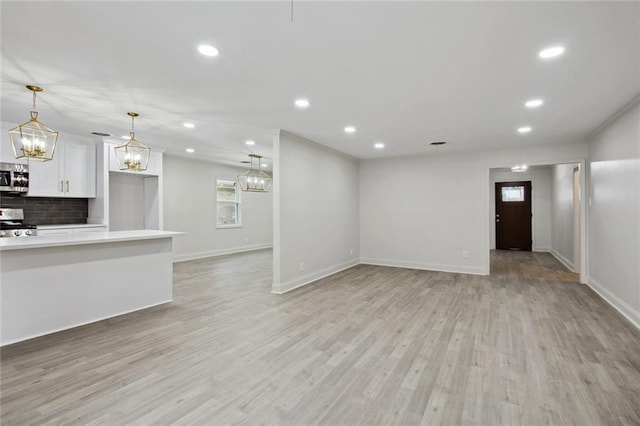 3313 Clifford Dr, Metairie, LA 70002 - unfurnished living room with recessed lighting, light wood-type flooring, baseboards, and a chandelier